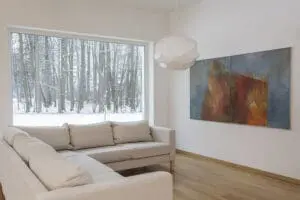 Interior living room with smooth white walls during winter, showing conditions that explain why interior paint cracks appear in winter
