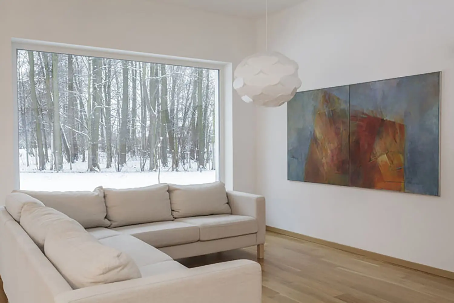 Interior living room with smooth white walls during winter, showing conditions that explain why interior paint cracks appear in winter