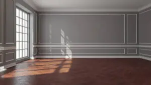 Gray living room walls with decorative trim and sunlight showing signs your interior walls need more than a touch-up