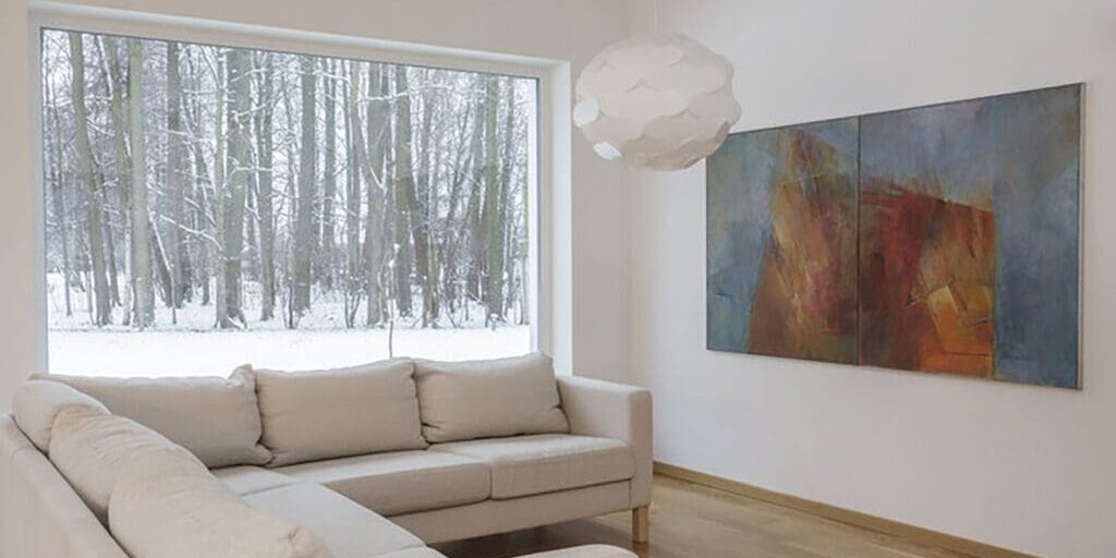 Interior living room with smooth white walls during winter, showing conditions that explain why interior paint cracks appear in winter